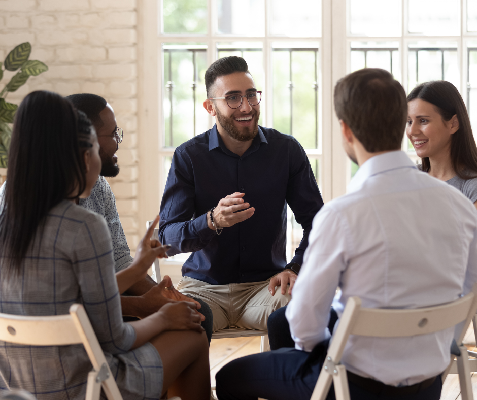 Group of colleagues siting in a tight circle and talking