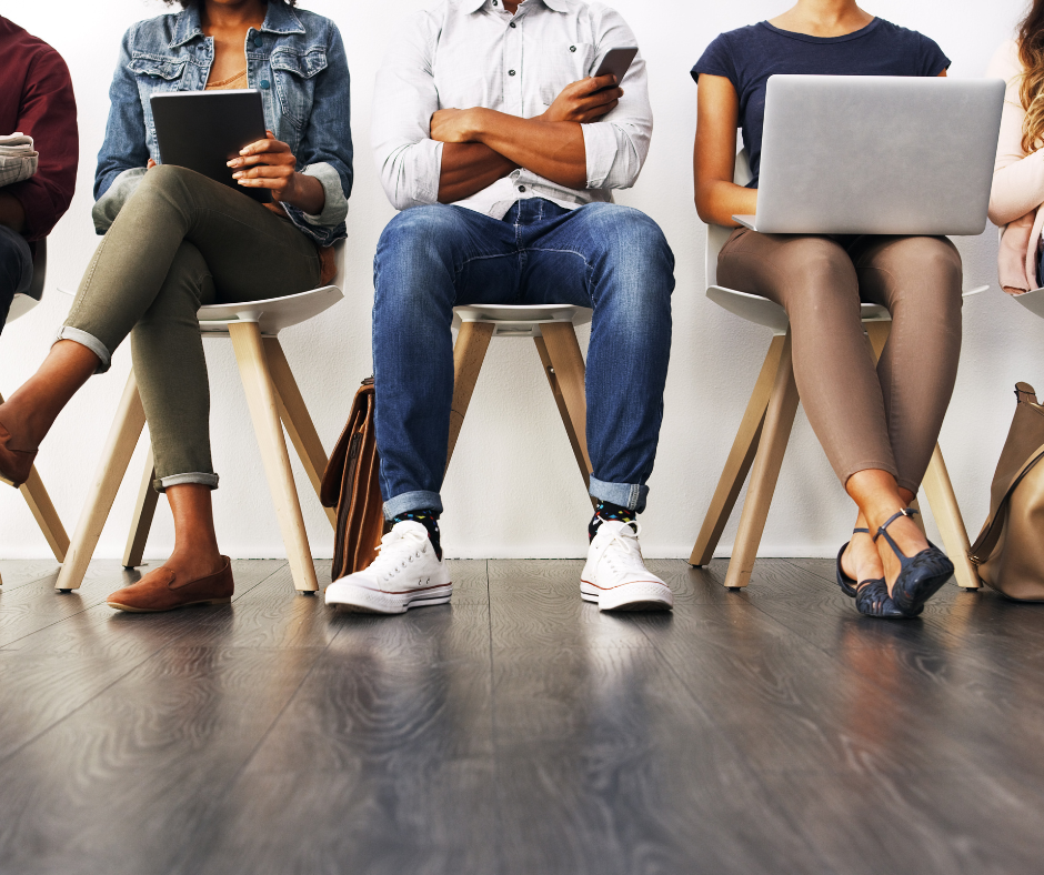Line of people - one with pad, one with laptop, one with arms folded